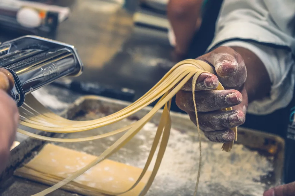 person making pasta tagliatelle